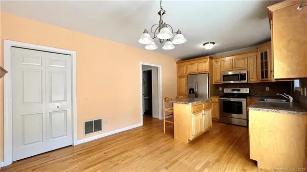 a kitchen with a stove a sink and a refrigerator
