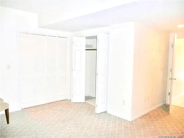 a view of a room with a white wall