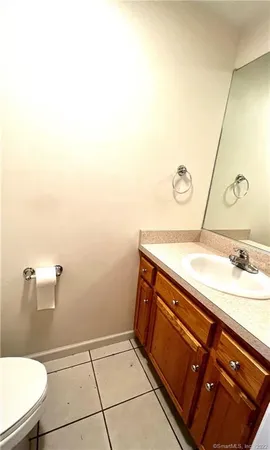 a bathroom with a sink a toilet and mirror