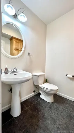 a white toilet sitting next to a bathroom sink
