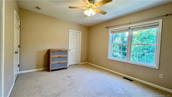 a view of room with window and ceiling fan