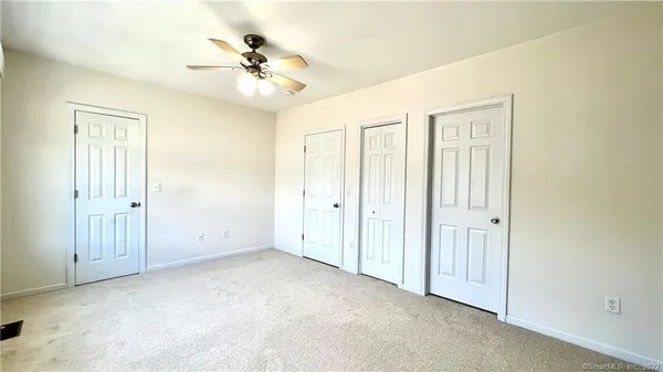 a view of an empty room with a ceiling fan