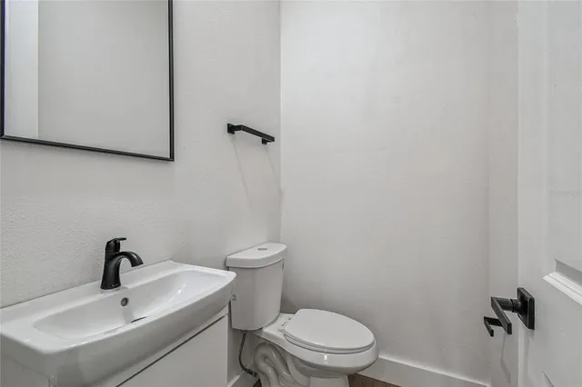 a white toilet sitting next to a bathroom sink