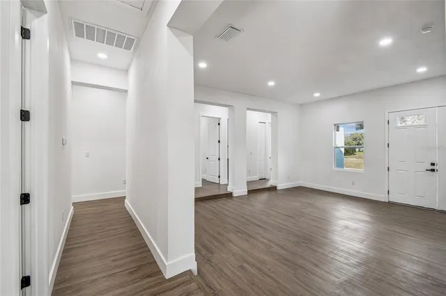 a view of a hallway with wooden floor