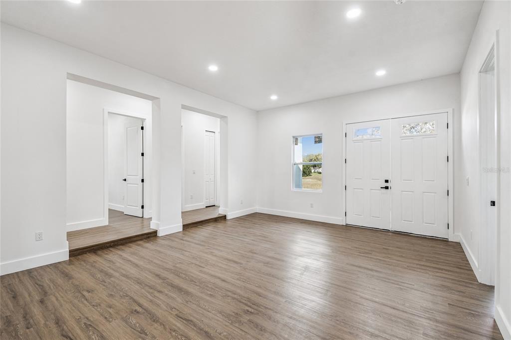 310 Waterfall Drive Spring Hill, FL 34608 - Photo 20 of 40 a view of an empty room with wooden floor