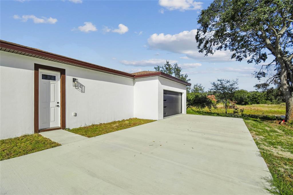 310 Waterfall Drive Spring Hill, FL 34608 - Photo 2 of 40 a view of an house with backyard and bushes