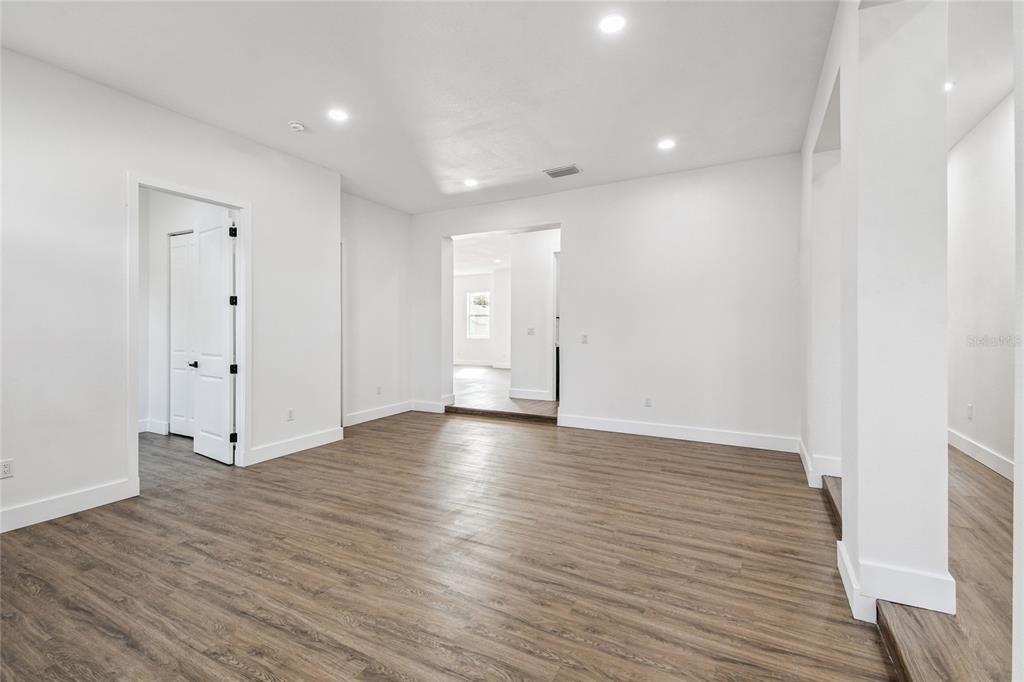 310 Waterfall Drive Spring Hill, FL 34608 - Photo 22 of 40 a view of wooden floor and windows in a room