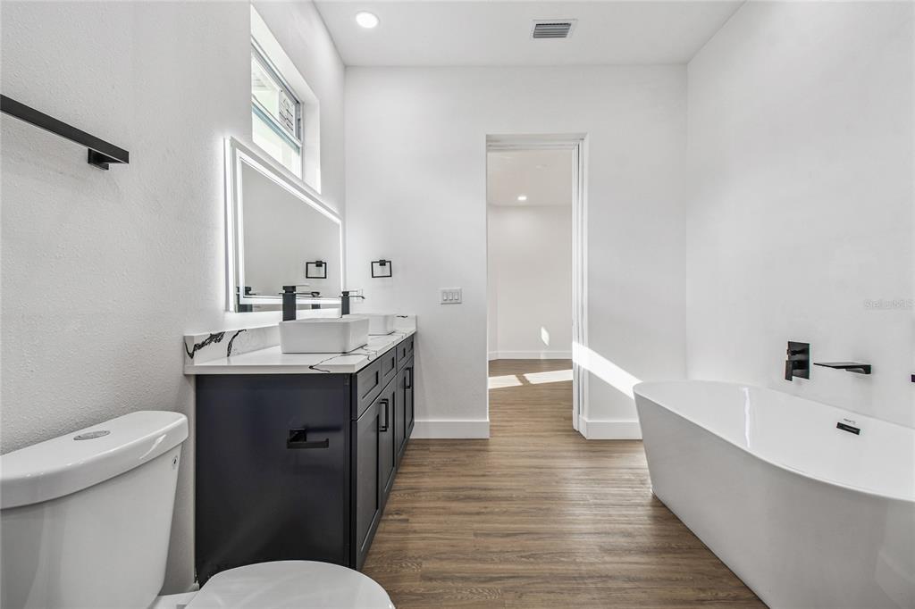 310 Waterfall Drive Spring Hill, FL 34608 - Photo 28 of 40 a bathroom with a sink a toilet and shower