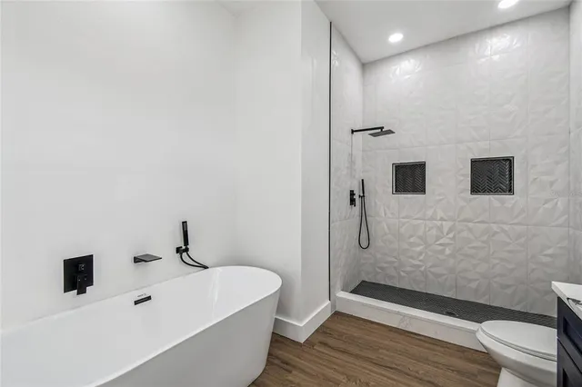 a bathroom with a bathtub and shower