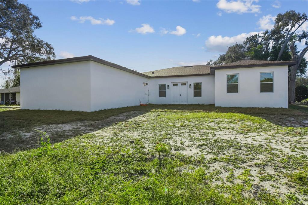 310 Waterfall Drive Spring Hill, FL 34608 - Photo 37 of 40 a view of a house with a yard