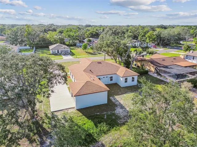 an aerial view of residential house with outdoor space and swimming pool
