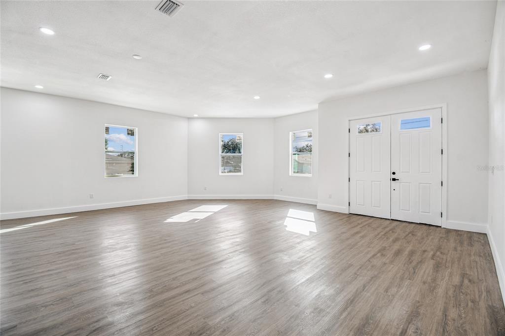 310 Waterfall Drive Spring Hill, FL 34608 - Photo 6 of 40 an empty room with wooden floor and windows