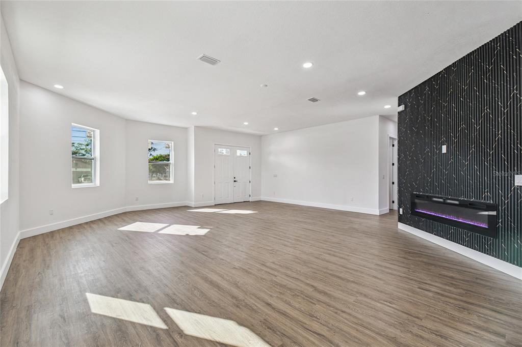 310 Waterfall Drive Spring Hill, FL 34608 - Photo 7 of 40 an empty room with wooden floor and windows