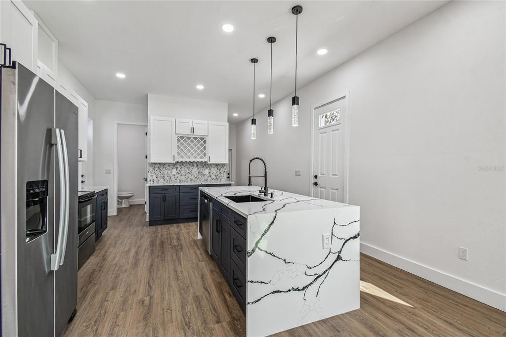 310 Waterfall Drive Spring Hill, FL 34608 - Photo 10 of 40 a kitchen with a sink stainless steel appliances and wooden floor
