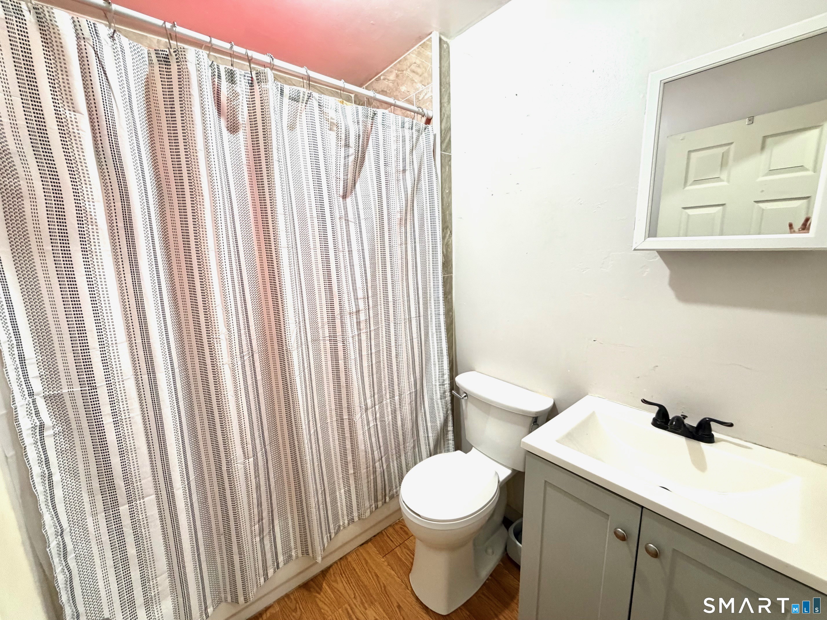 24 Byron Avenue Ansonia, CT 06401 - Photo 11 of 21 a white toilet sitting next to a bathroom sink