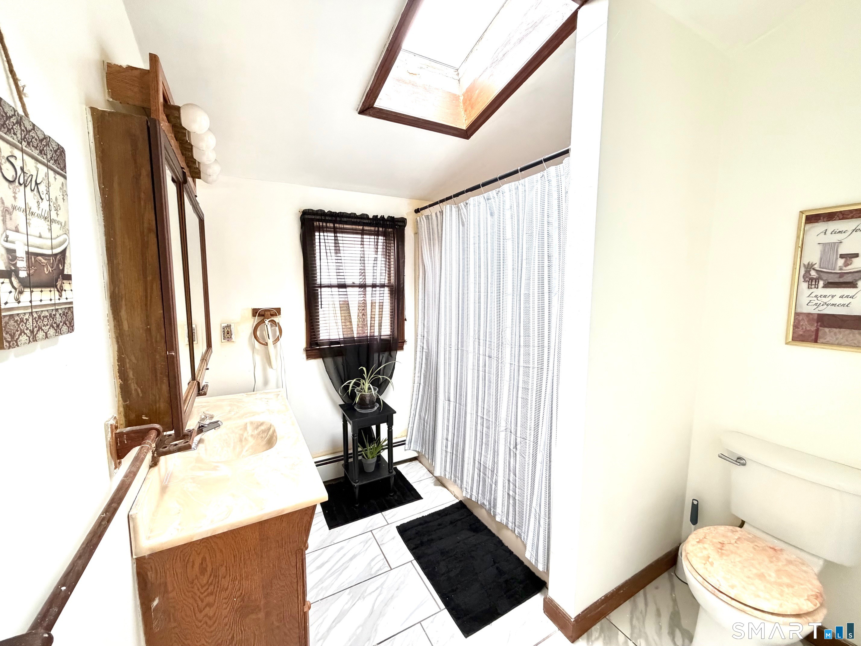 24 Byron Avenue Ansonia, CT 06401 - Photo 16 of 21 a bathroom with a sink toilet and shower