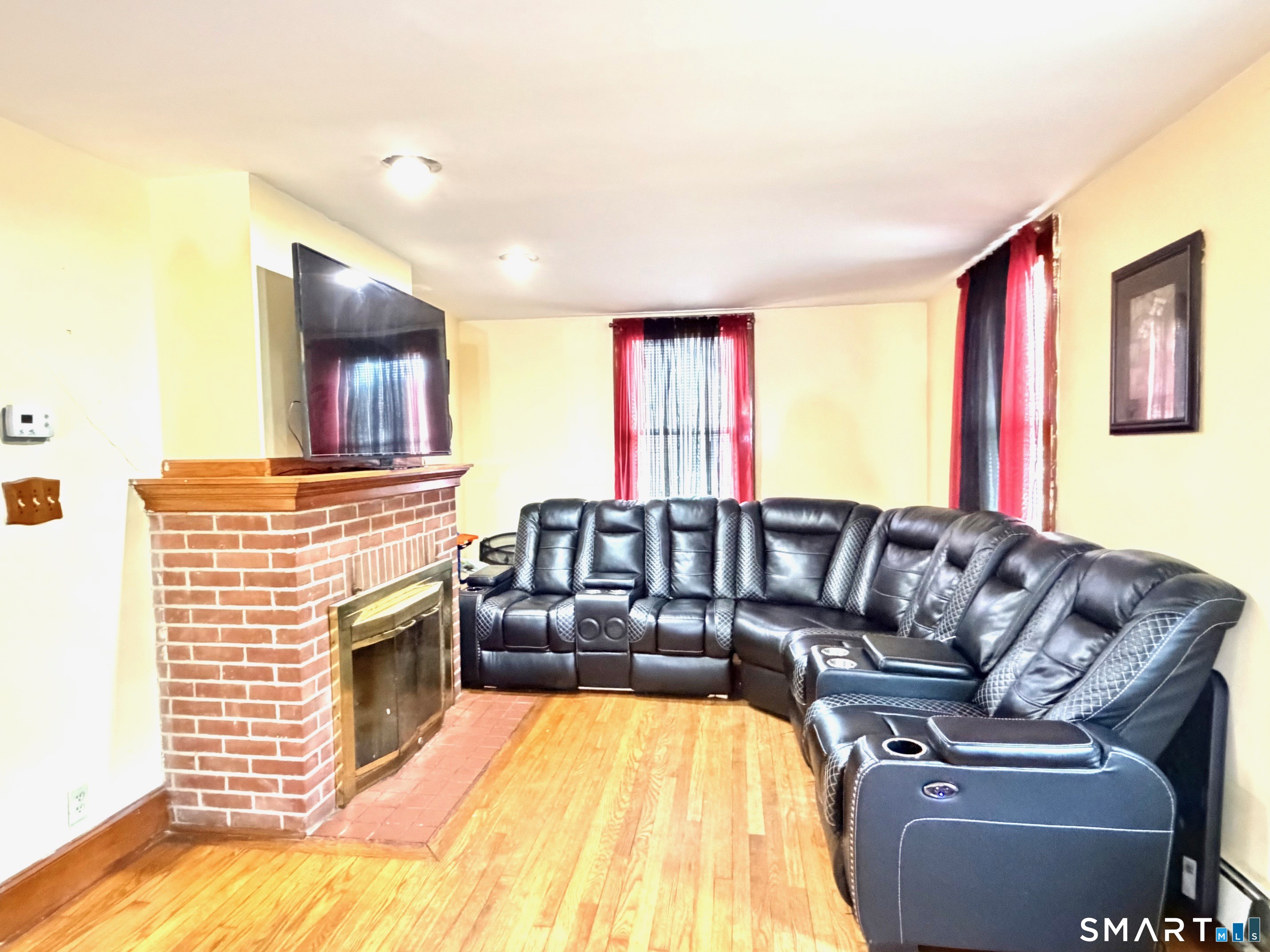 24 Byron Avenue Ansonia, CT 06401 - Photo 4 of 21 a living room with furniture and a fireplace