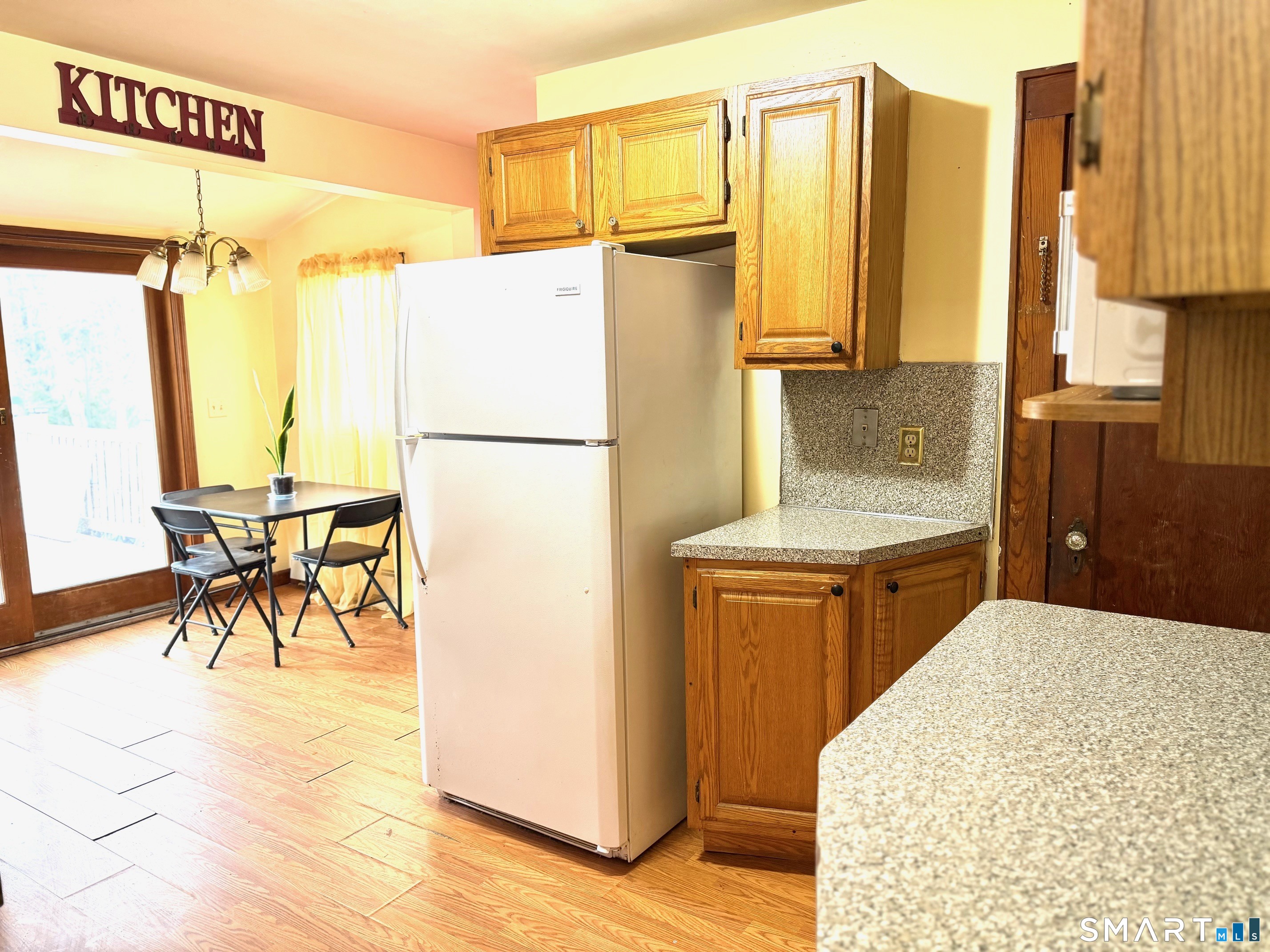 24 Byron Avenue Ansonia, CT 06401 - Photo 8 of 21 a kitchen with a refrigerator and a table