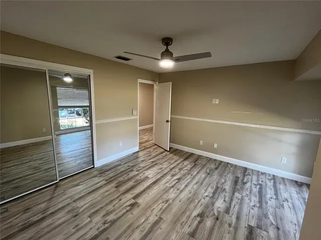 a view of an empty room and wooden floor