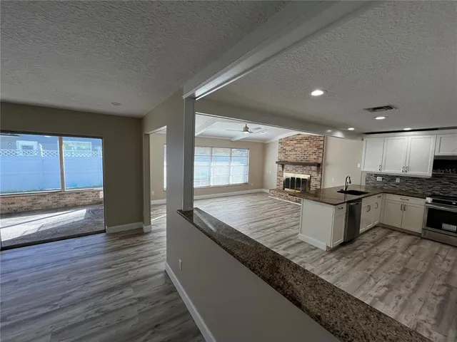 a large kitchen with kitchen island a large counter space and stainless steel appliances