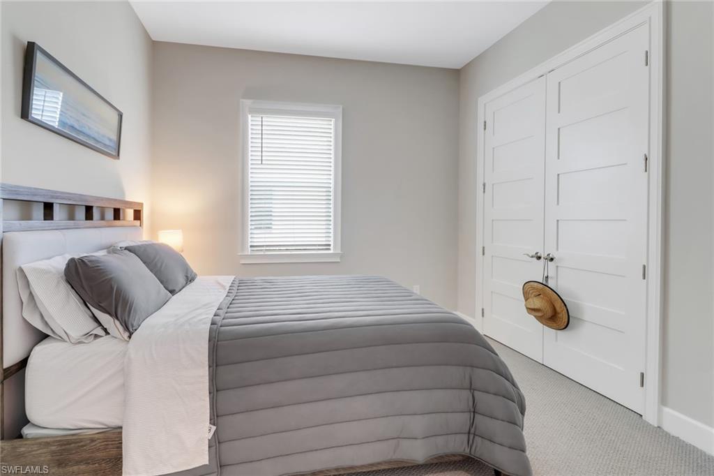 6299 Arriba Avenue Naples, FL 34113 - Photo 17 of 26 Bedroom with carpet and a closet