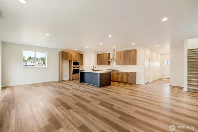 a view of kitchen with kitchen island wooden floor and center island