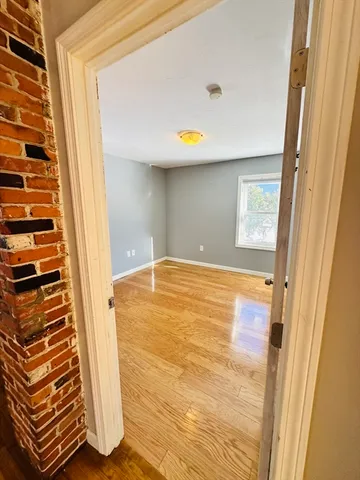 a view of an empty room with wooden door