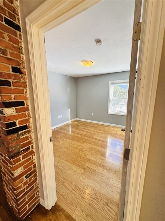 82 East High Street, Unit 1 Avon, MA 02322 - Photo 11 of 21 a view of an empty room with wooden door