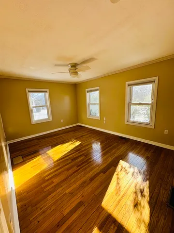 a view of a livingroom with wooden floor and a window