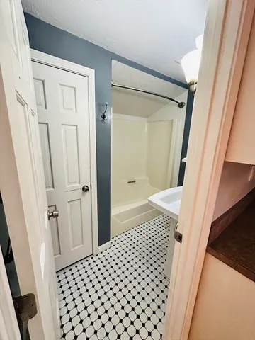 a bedroom with a sink and a mirror