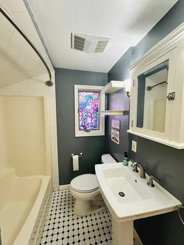 a bathroom with a sink a toilet and a mirror