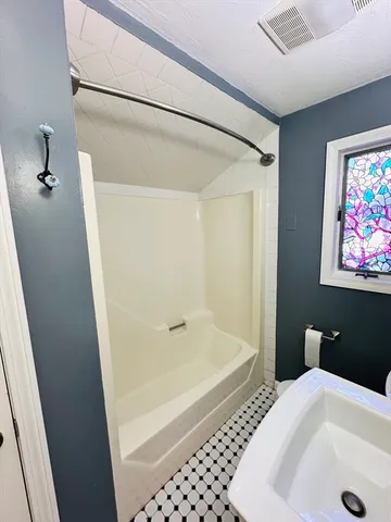 a bathroom with a bathtub and a shower