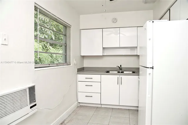 a kitchen with a stove a sink and a window