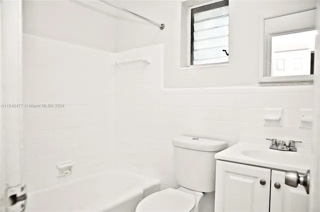 a bathroom with a toilet a sink and a bathtub