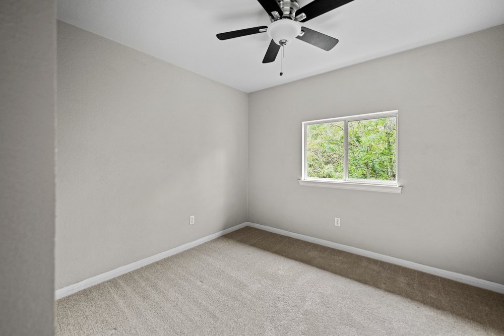 2823 Lantana Ridge Drive Austin, TX 78732 - Photo 23 of 34 an empty room with a window and a fan