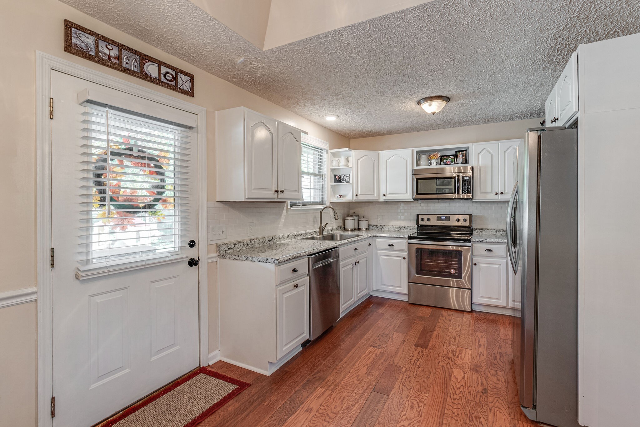 1686 Mann Road Lebanon, TN 37087 - Photo 9 of 31 a kitchen with a refrigerator a stove top oven and kitchen island