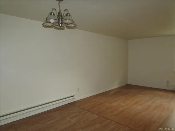 an empty room with a empty space and a chandelier fan