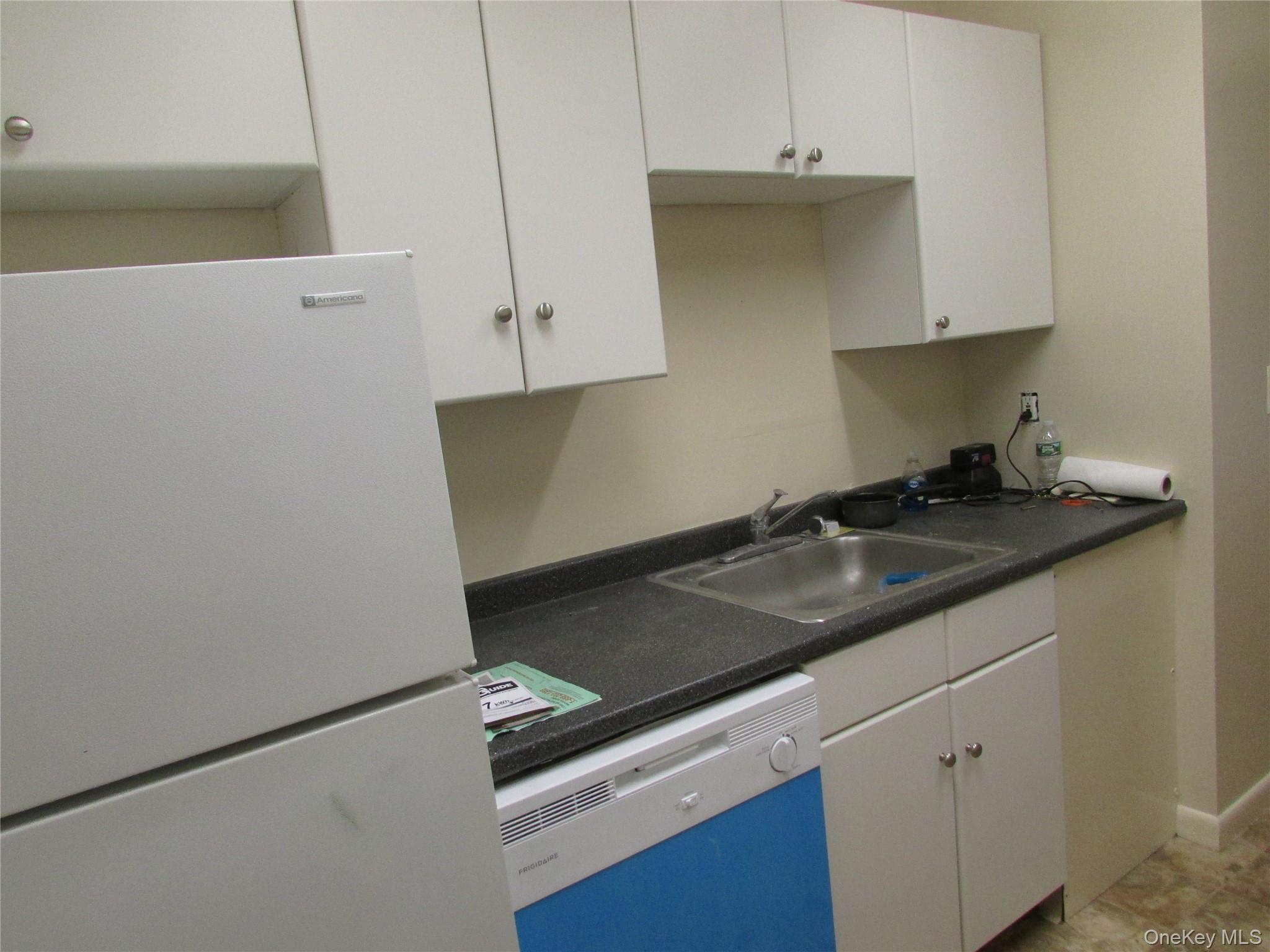 9 White Gate Road, Unit J Wappingers Falls, NY 12590 - Photo 6 of 17 Kitchen with refrigerator, dishwasher, white cabinets, and dark countertops
