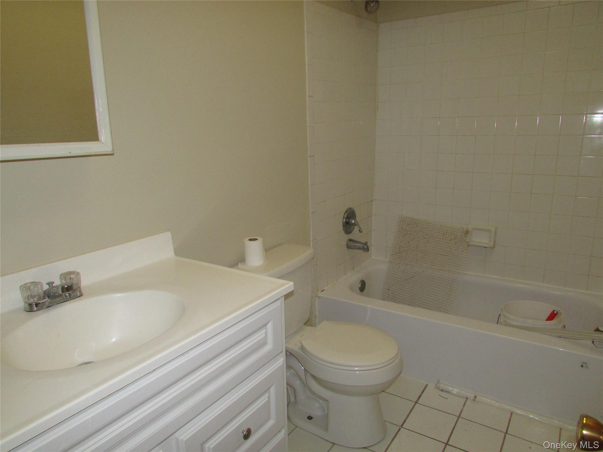 9 White Gate Road, Unit J Wappingers Falls, NY 12590 - Photo 8 of 17 Bathroom featuring light tile patterned flooring, shower / tub combination, and vanity