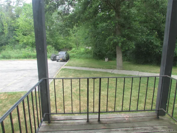a view of a balcony with wooden floor