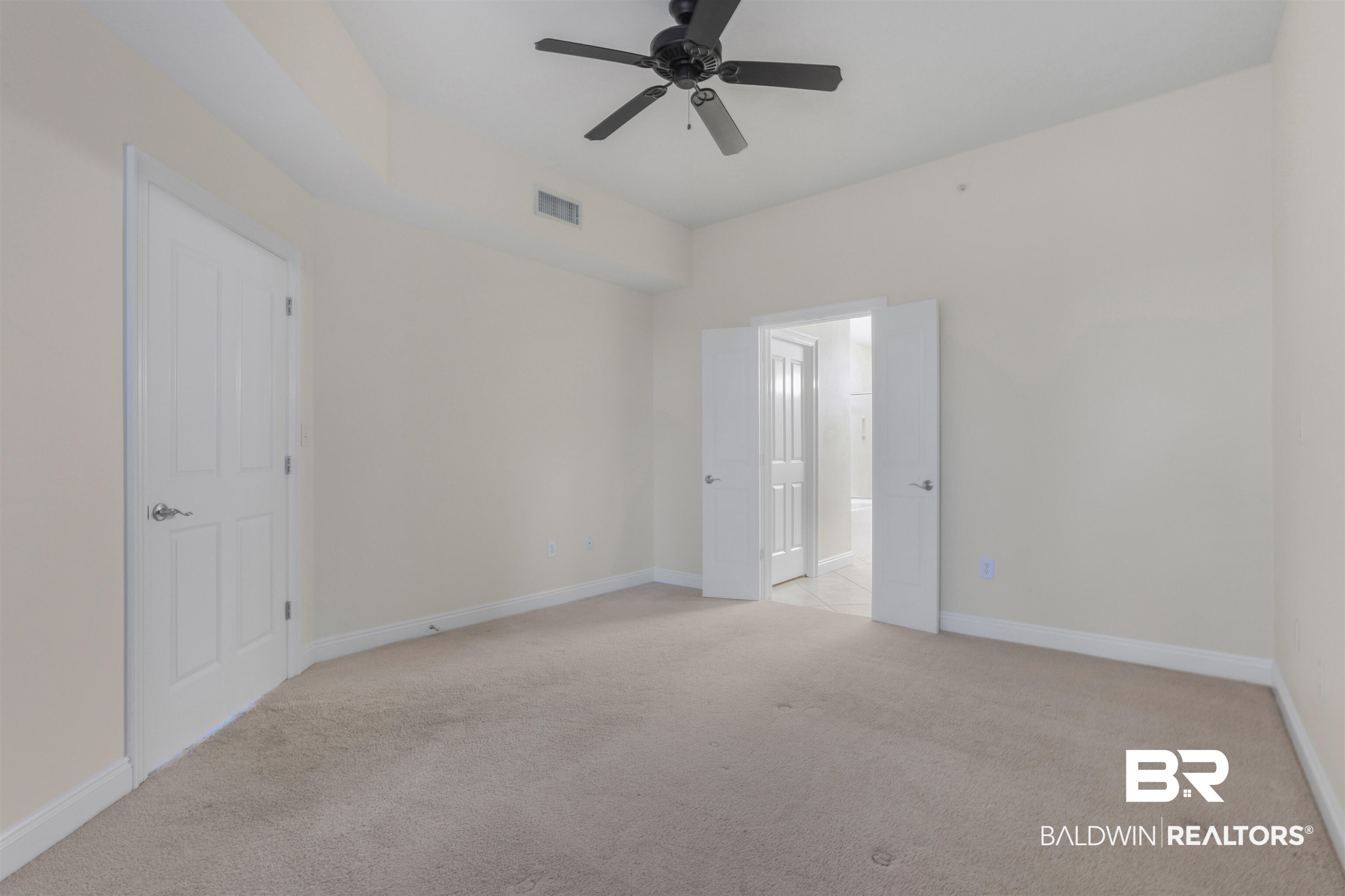 28250 Canal Road, Unit 106 Orange Beach, AL 36561 - Photo 18 of 50 Unfurnished room featuring light carpet and a ceiling fan