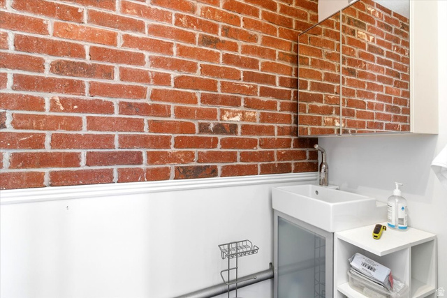 161 25th Street, Unit 6B Ogden, UT 84401 - Photo 9 of 20 Exposed brick wall with white wainscoting and trim