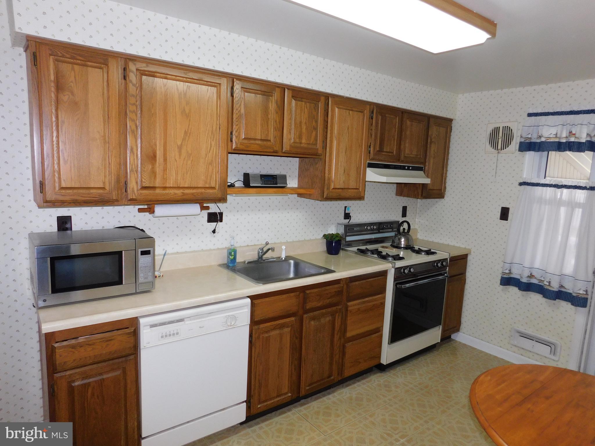 1759 Melbourne Road Baltimore, MD 21222 - Photo 5 of 30 a kitchen with stainless steel appliances granite countertop a stove a sink dishwasher and a refrigerator with wooden countertops