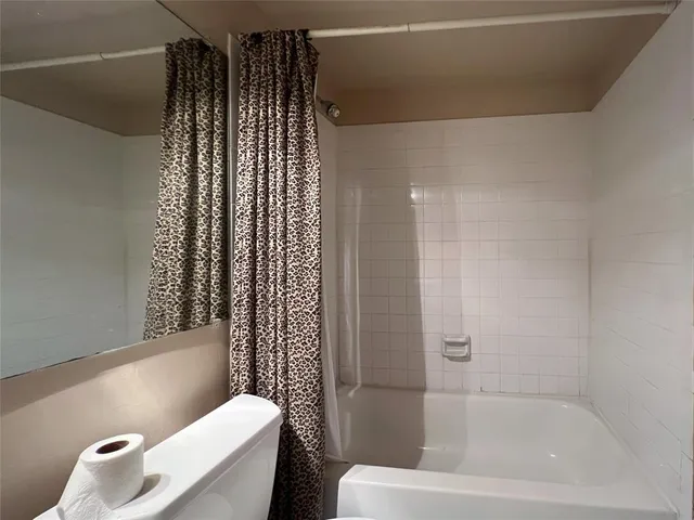 a bathroom with a bathtub and shower