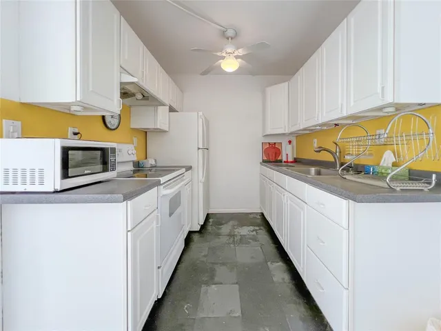 a kitchen with stainless steel appliances a sink a stove and cabinets