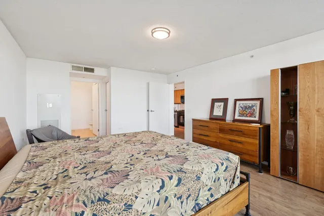 a bedroom with a bed and a dresser