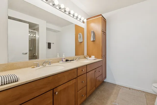 a bathroom with a double vanity sink mirror and double