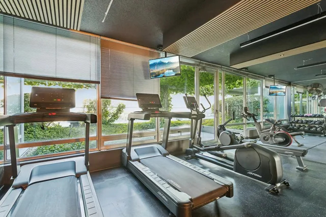 a view of a gym with wooden floor and outdoor seating
