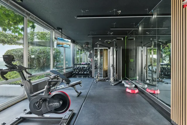 a room with gym equipment and a large window