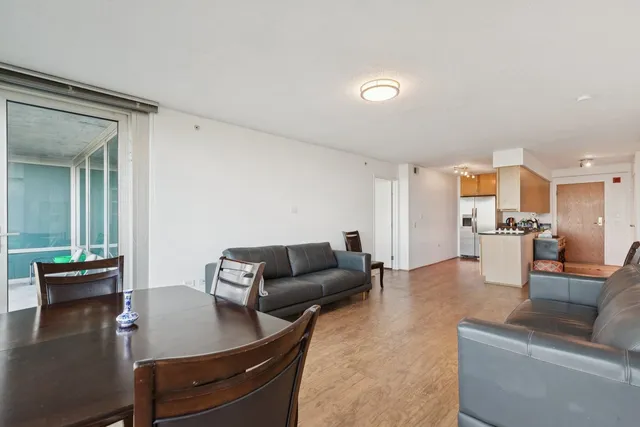 a living room with furniture and view of kitchen